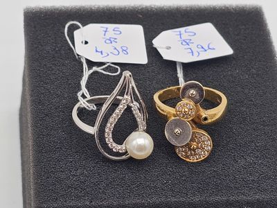 deux bagues et une paire de boucles d'oreilles sont posées sur un écrin noir