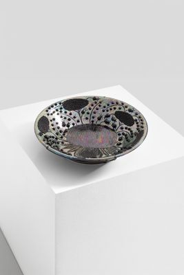 a black and white bowl sitting on top of a white box