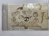 a small envelope with stamps on it sitting on a table