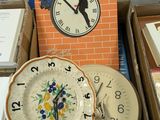 a lot of different clocks and plates on the table