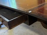 a table with a drawer underneath it in a room
