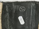 a black suitcase with a tag on it sitting on a table
