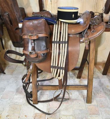 a saddle with a hat on top of it in a room