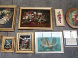 a lot of framed pictures and paintings on the floor