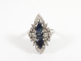 a close up of a blue sapphire and diamond ring on a white background