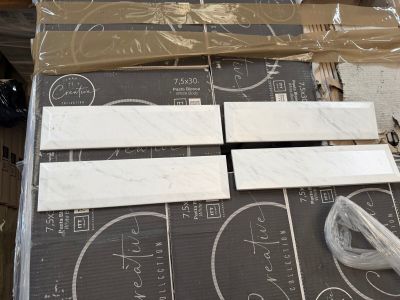 four pieces of marble sitting on top of a cardboard box