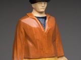 figurine of a man holding two jugs and a hat