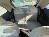 the back seats of a small car are empty in the sun