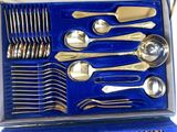 a blue box with silverware in it on a table