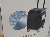 a box with a black suitcase on top of it