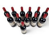 several bottles of wine are lined up in a row on a white surface