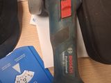 a cordless drill on a table next to a pair of shoes
