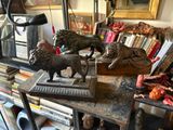 two statues of lions on a table in a room