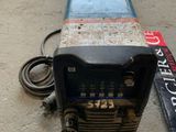 an image of a welding machine sitting on the ground next to a sign