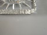 a glass of water sitting on top of a glass coaster