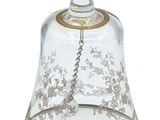 a glass bell with a gold decoration on it