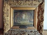 un vieux cadre contenant le portrait d'une femme dans un paysage