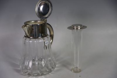 a small glass pitcher next to a small glass container