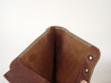 someone is holding a brown leather wallet in their hand