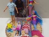 three barbie dolls that are sitting on a table