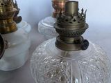 three glass lamps that are sitting on a table