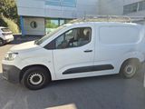 the white van is parked in the parking lot outside of the building
