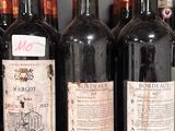 several bottles of wine are lined up on a shelf in a wine cellar