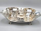 a silver plate with two cups on it on a table
