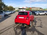 a red car that is parked in a parking lot