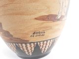 a vase that has a picture of a man on it