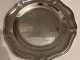 a silver plate on a table with a white background