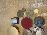 a lot of coins on a wooden table with a piece of paper