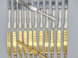 a lot of silverware on a table with a knife and fork