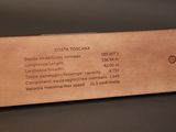 the back of a wooden plaque with a business card on it