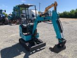 the back end of a small excavating machine parked in a lot