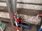 a red and white tape on the ground next to some tools