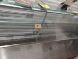 a glass display case with a lot of food inside of it