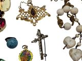 a lot of jewelry that is laying out on a white surface