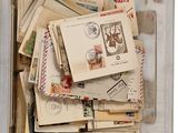 a plastic container filled with lots of stamps and postcards