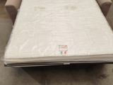 a couch that is sitting in a room with a mattress on it
