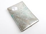 a silver case with a tag on it on a white surface