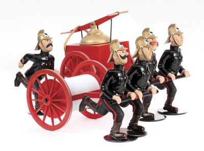four figurines of men in uniform sitting on a firetruck