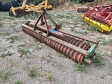 deux vieux outils agricoles qui traînent dans l'herbe