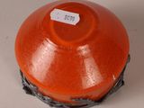 an orange vase with a tag on it