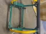 a picture of a green and yellow ladder on a concrete floor
