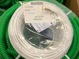 green hoses are stacked on top of each other in a box