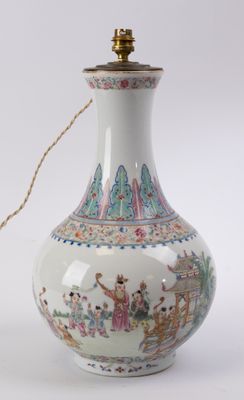 a white vase that has a handle on it