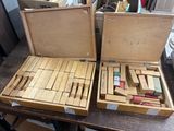 two wooden blocks in a wooden box on a table