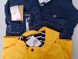 a pile of clothing on a table with a tag on it