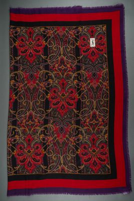 a red, black and yellow scarf with a design on it